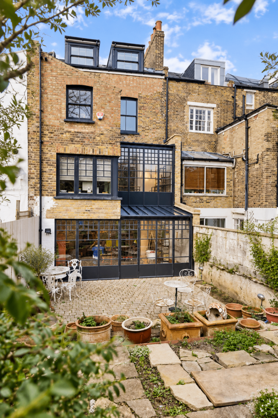 Brick townhouse with a glazed rear extension and garden