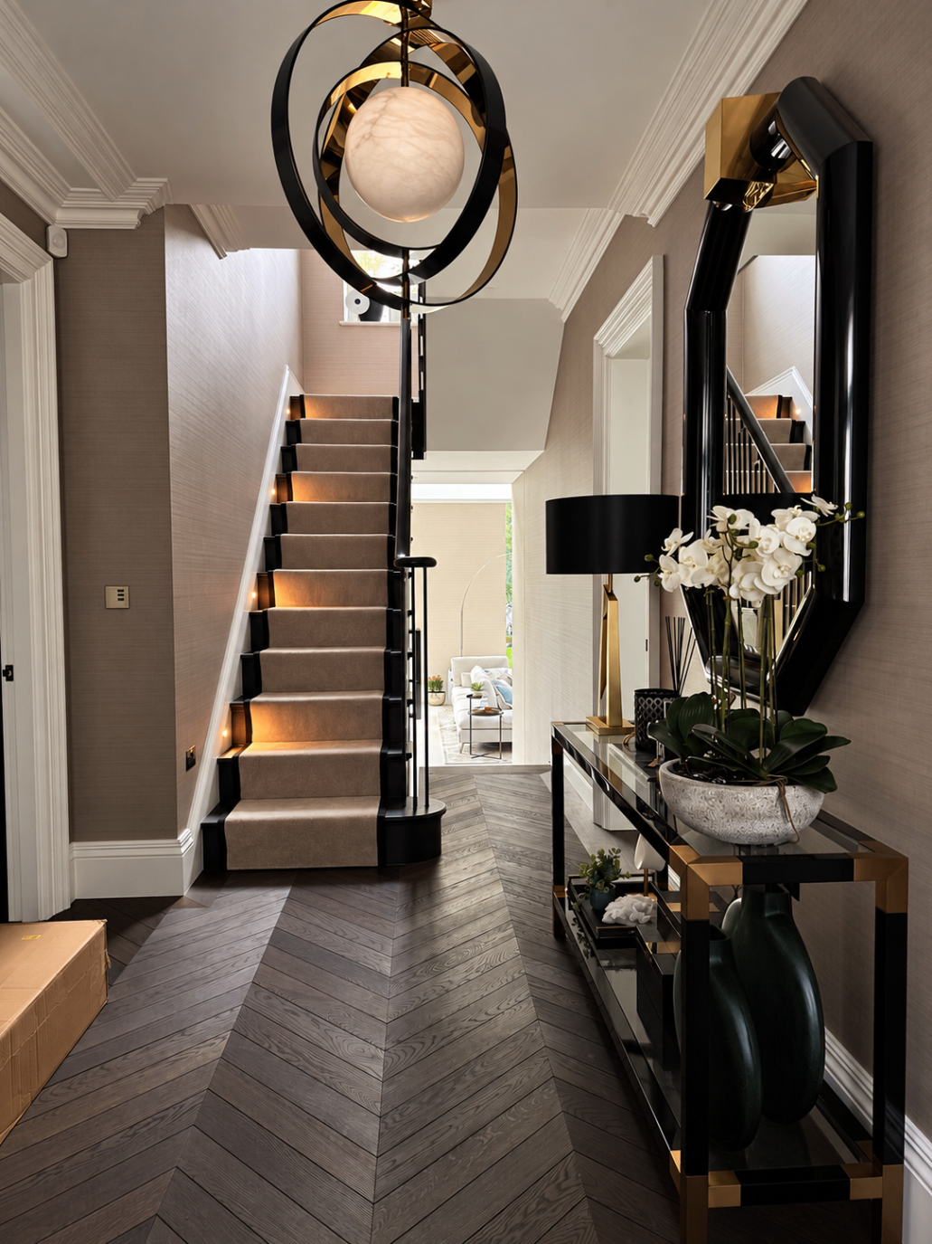 Finished entrance hallway with staircase and pendant lighting