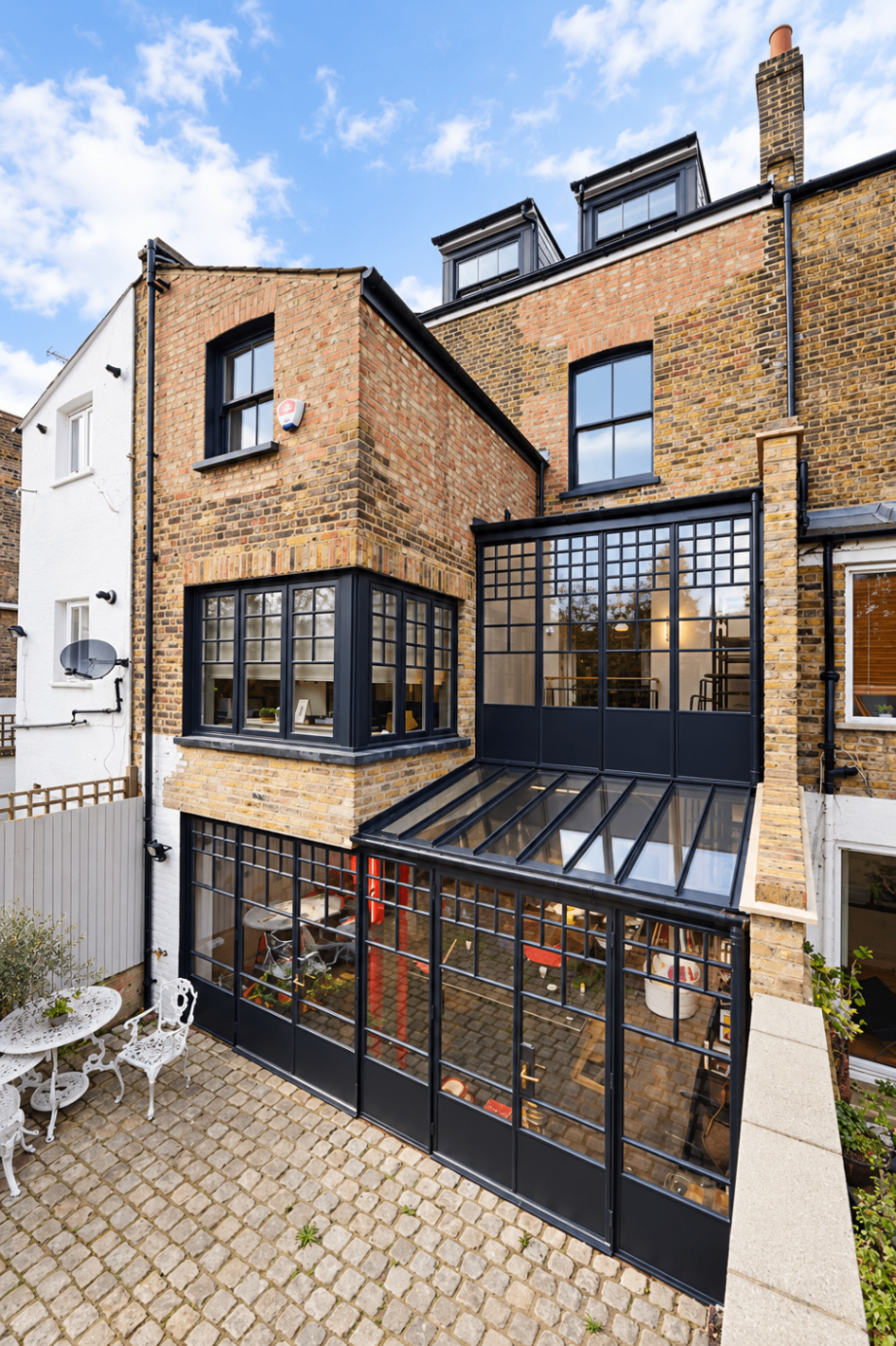 Rear townhouse extension with black-framed glazing